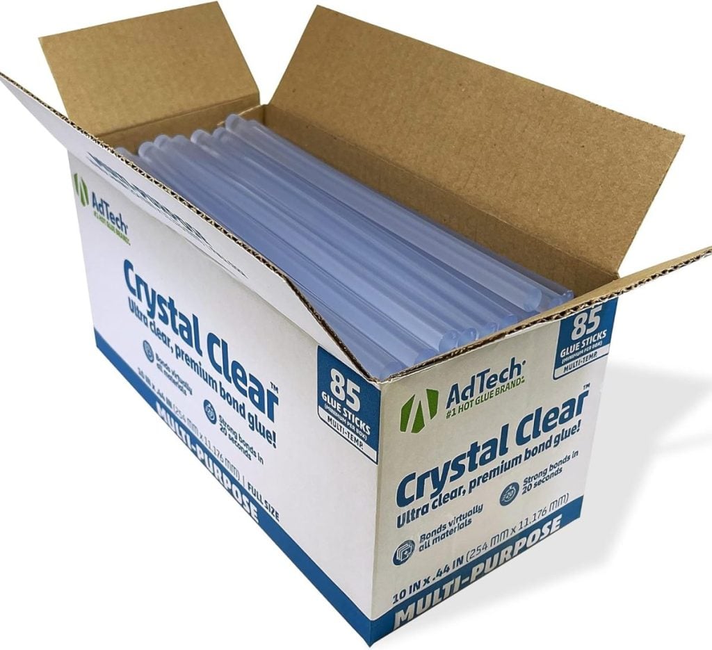 An open box of AdTech Crystal Clear hot glue sticks, containing 85 pieces, perfect for crafting beautiful wreaths for fall.