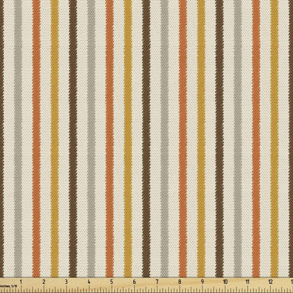 A fabric swatch with a striped pattern in orange, brown, and beige evokes the warm tones of fall pumpkins. A measuring tape shows the width as 12 inches.