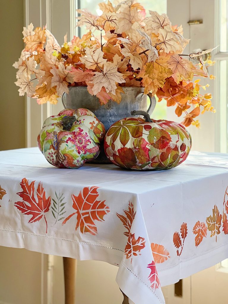 A handmade fall tablecloth using stencils and metallic paint.