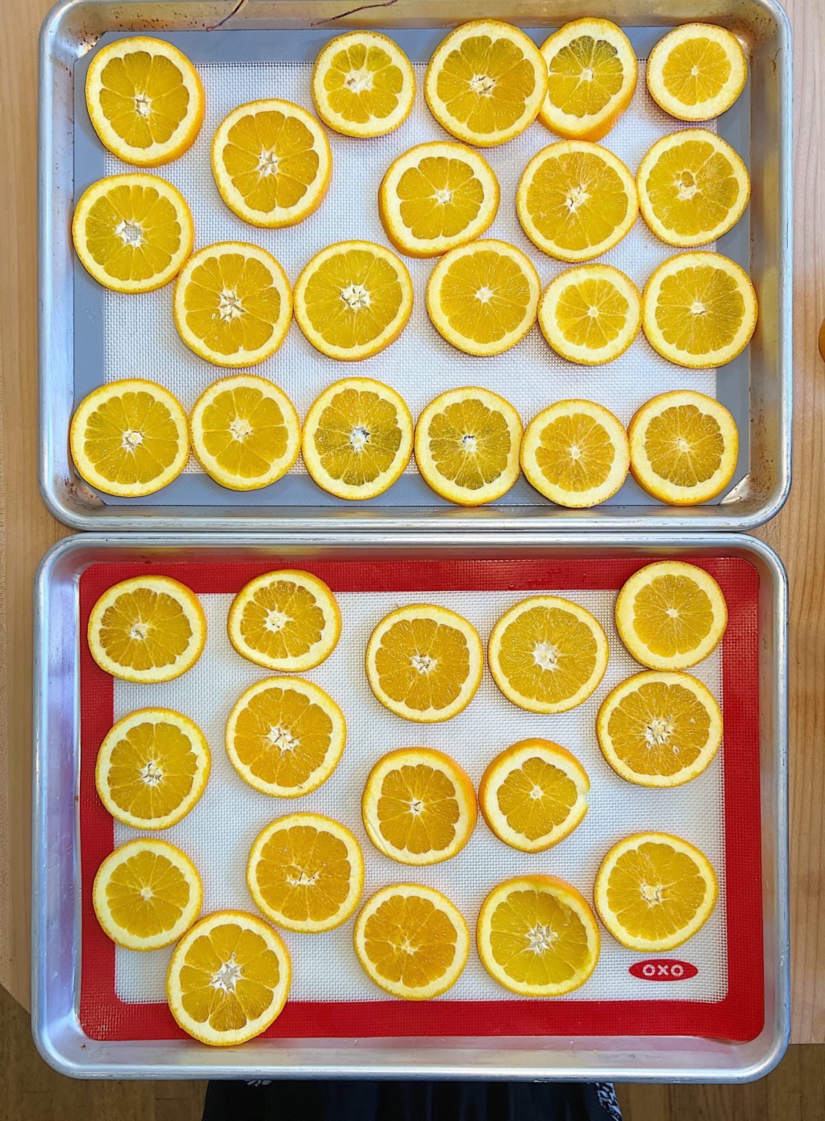A DIY Halloween wreath made with a eucalyptus wreath and dried orange slices.