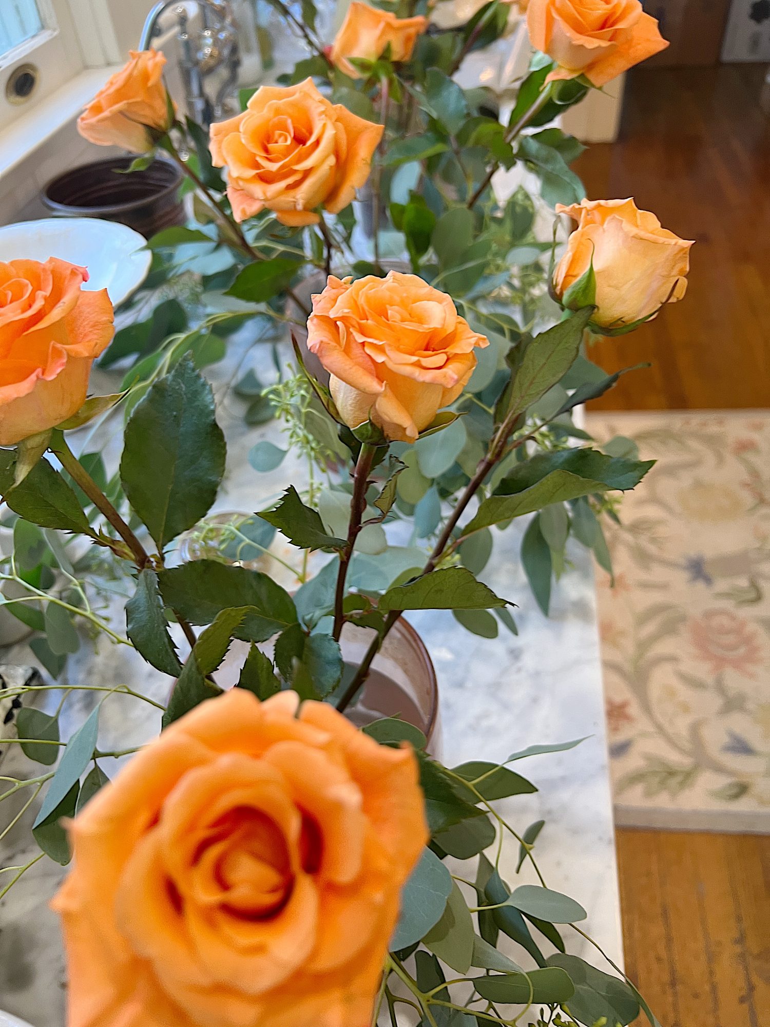 Arranging the flower centerpieces for a dinner for eight which was planned and hosted by us to benefit charity.