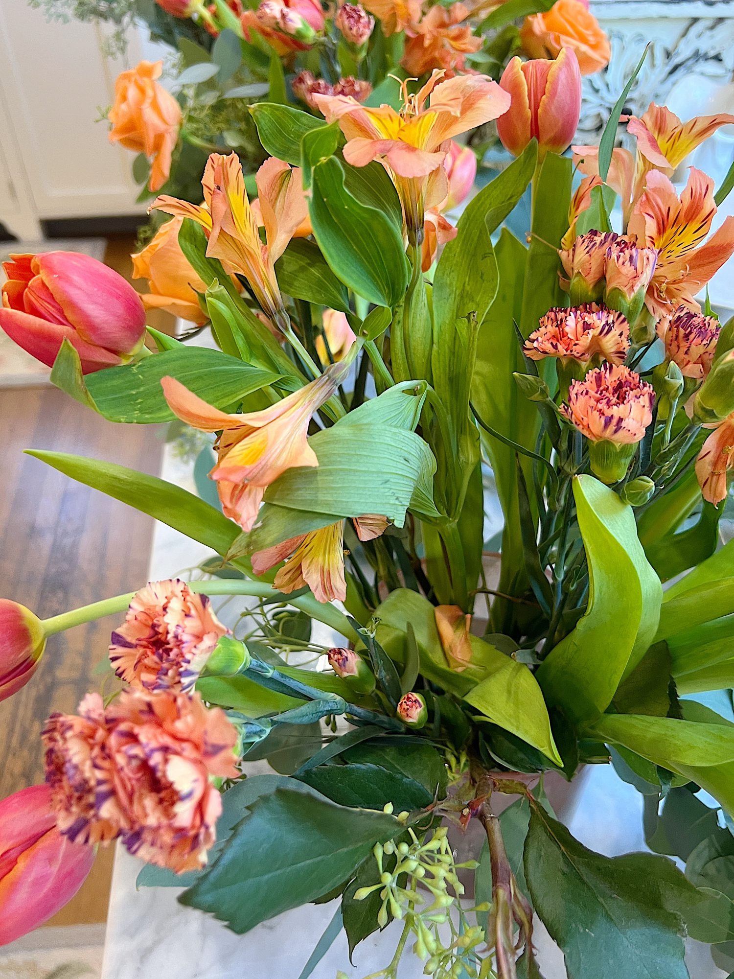 Arranging the flower centerpieces for a dinner for eight which was planned and hosted by us to benefit charity.