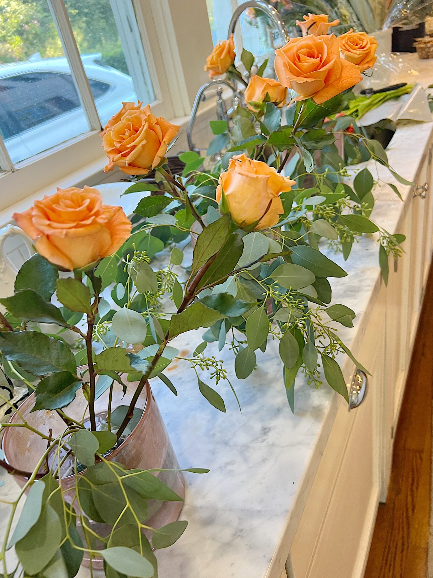 Arranging the flower centerpieces for a dinner for eight which was planned and hosted by us to benefit charity.