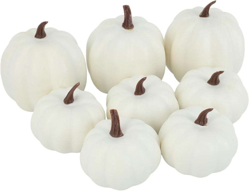 Seven white pumpkins with brown stems, perfect for any pumpkin craft, are arranged together against a white background.