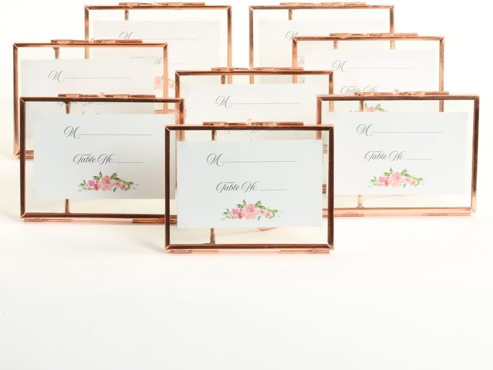 Several copper-framed table cards are standing, each with floral designs and space for names and table numbers, making them a perfect fall craft idea.