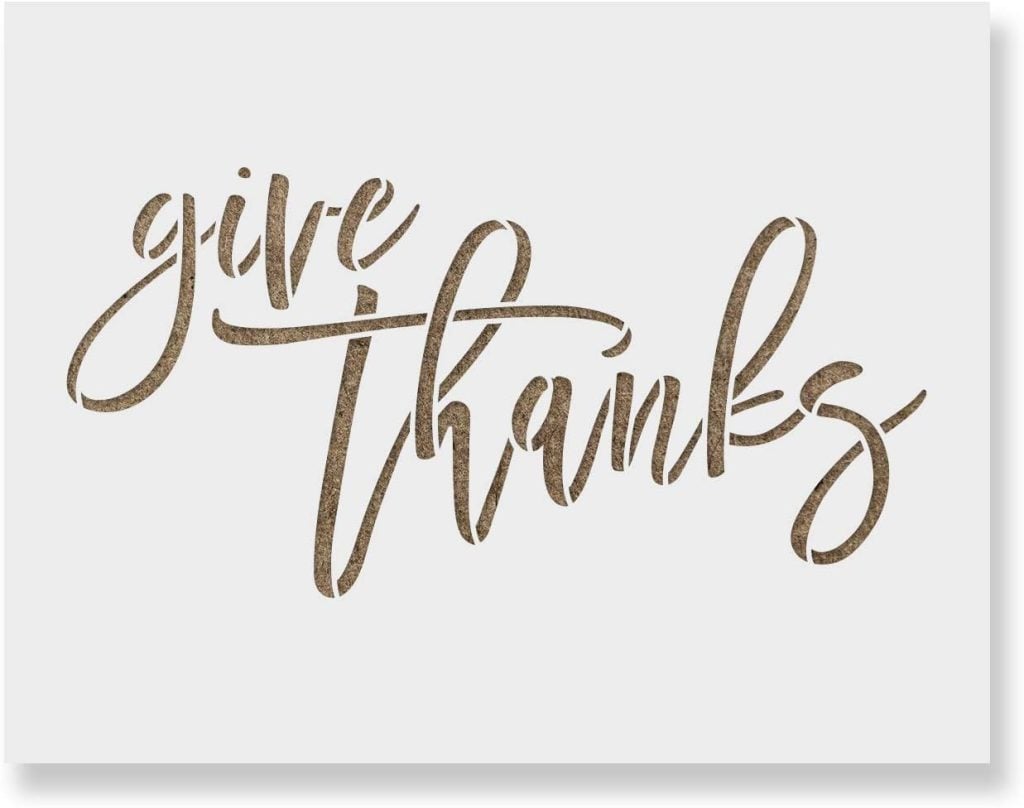 Text reads "give thanks" in cursive, gold-colored letters on a white background, reminiscent of a festive dinner table adorned with dishes like roasted turkey and purple sweet potato pie.