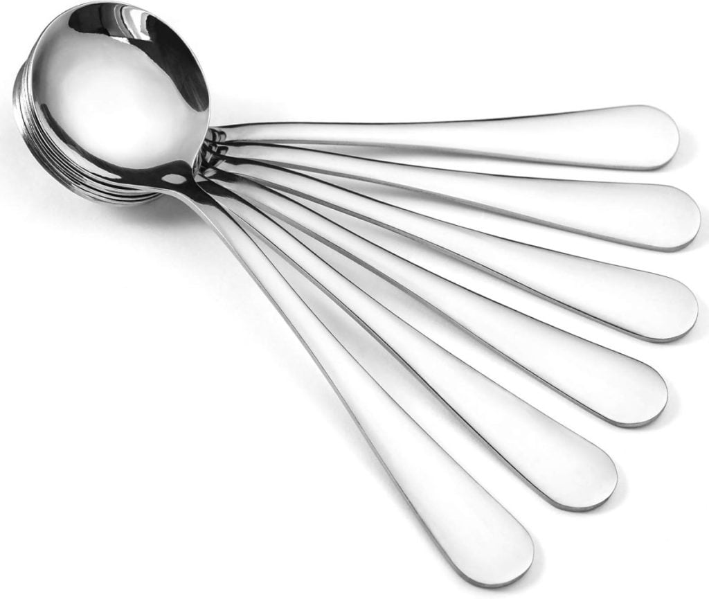 Six silver spoons fan outwards in a radial arrangement on a white surface, reminiscent of the elegant simplicity found in fall soup recipes.