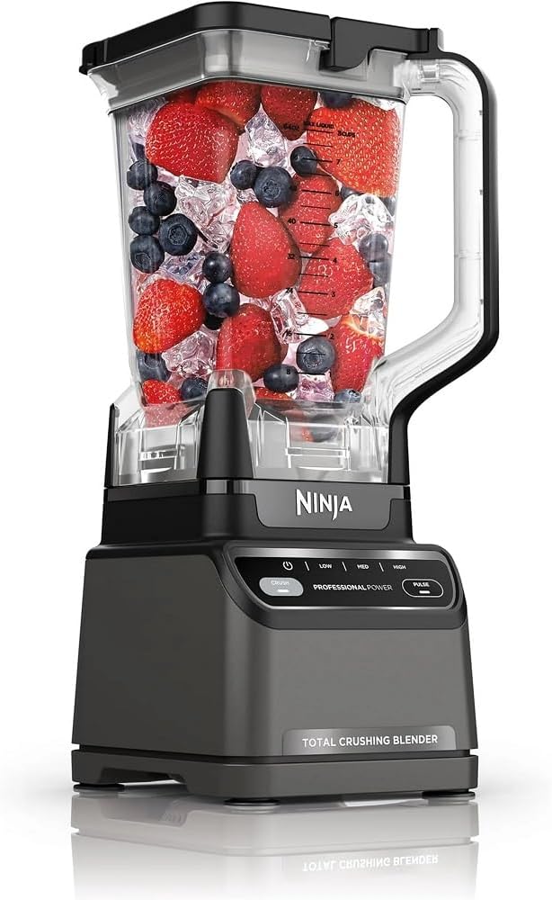 A blender filled with strawberries, blueberries, raspberries, purple sweet potato, and ice cubes.