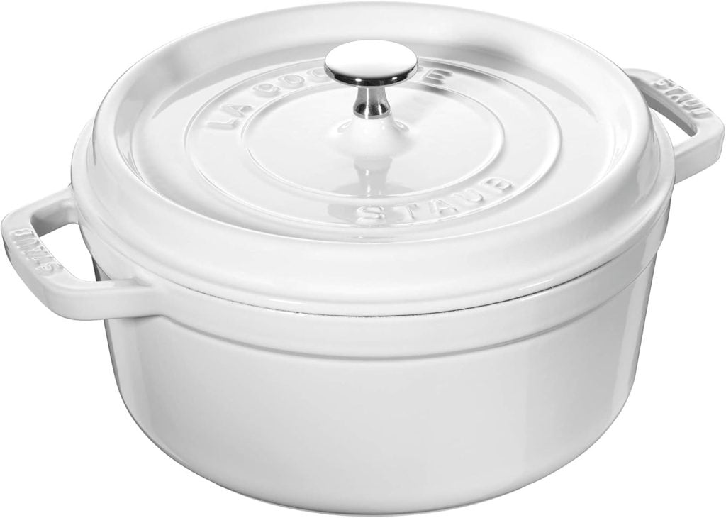 White cast iron dutch oven with a lid and handle, perfect for simmering fall soup recipes, labeled "La Cocotte Staub.