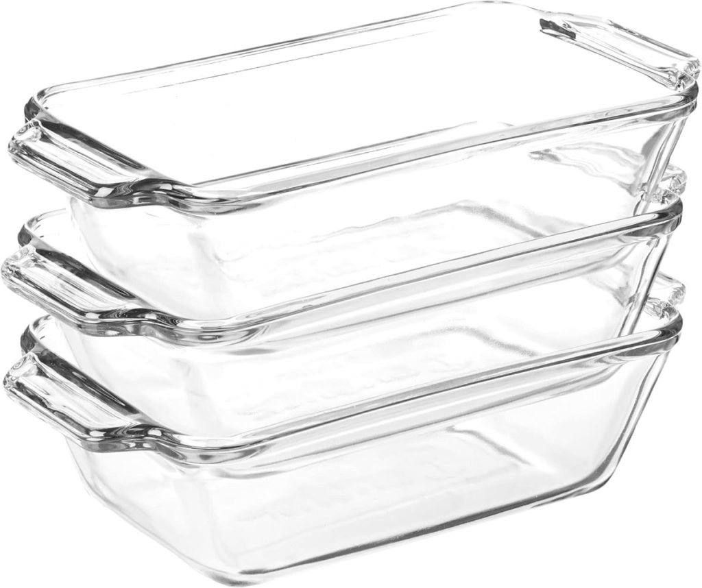 Three stacked rectangular glass baking dishes with handles, each featuring a clear lid, perfect for baking and displaying your delicious pumpkin banana bread.