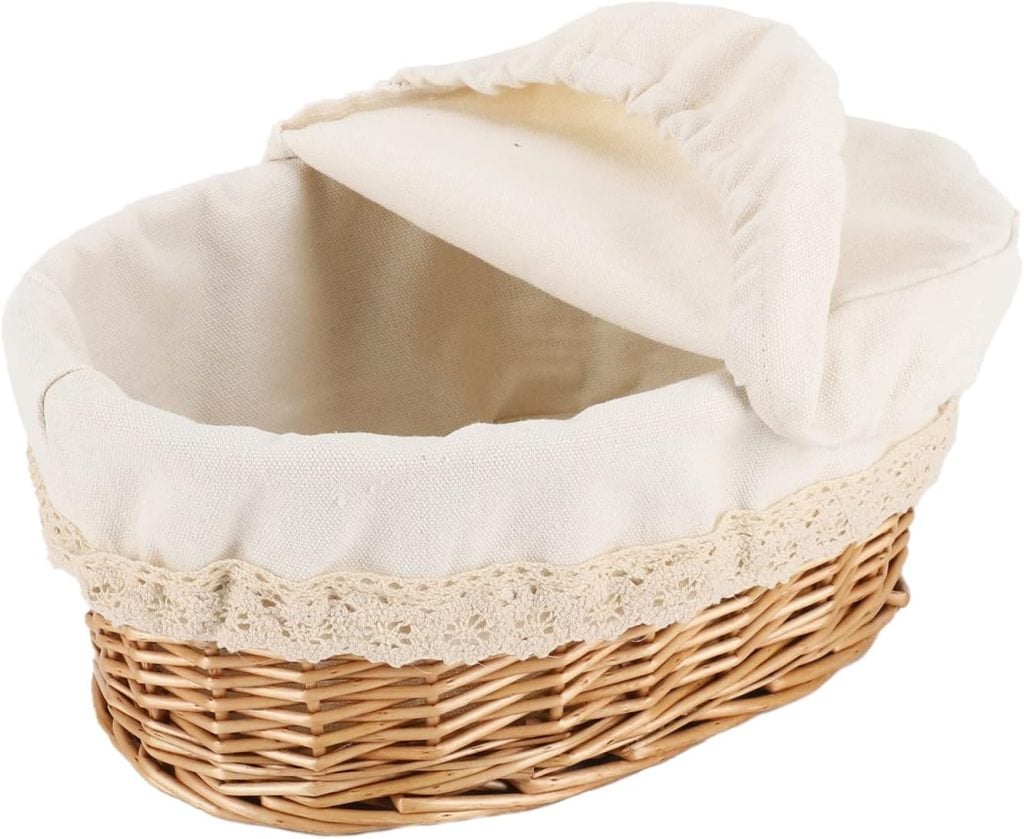 A wicker basket with a beige cloth lining and lace trim, perfect for storing fall soup recipes, featuring a loose fabric lid.