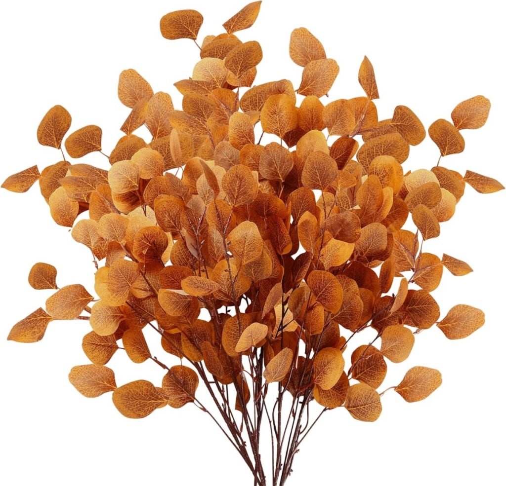 A bouquet of dried orange leaves with thin stems, perfect for adding a rustic touch to your pumpkin craft projects, set against a crisp white background.