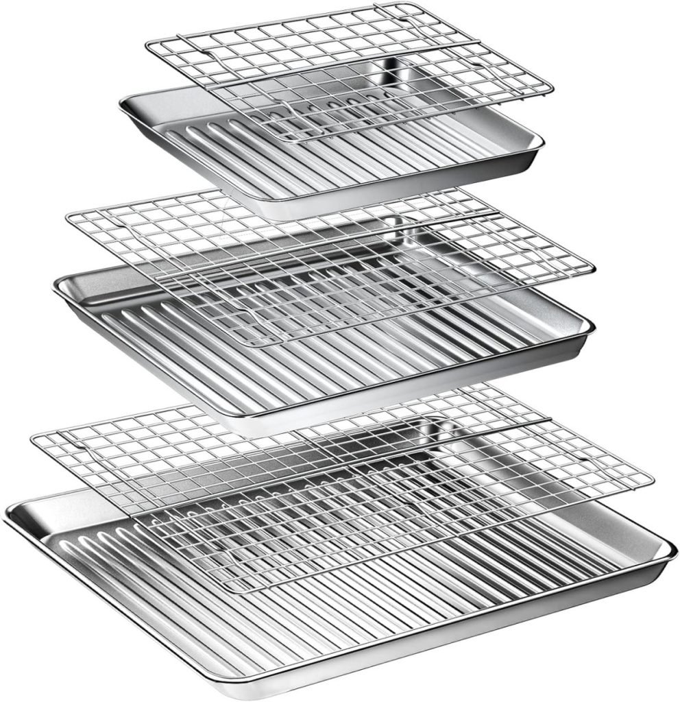 Four metal baking pans with grooves and matching wire racks are stacked in ascending order, perfect for baking Halloween sugar cookies.