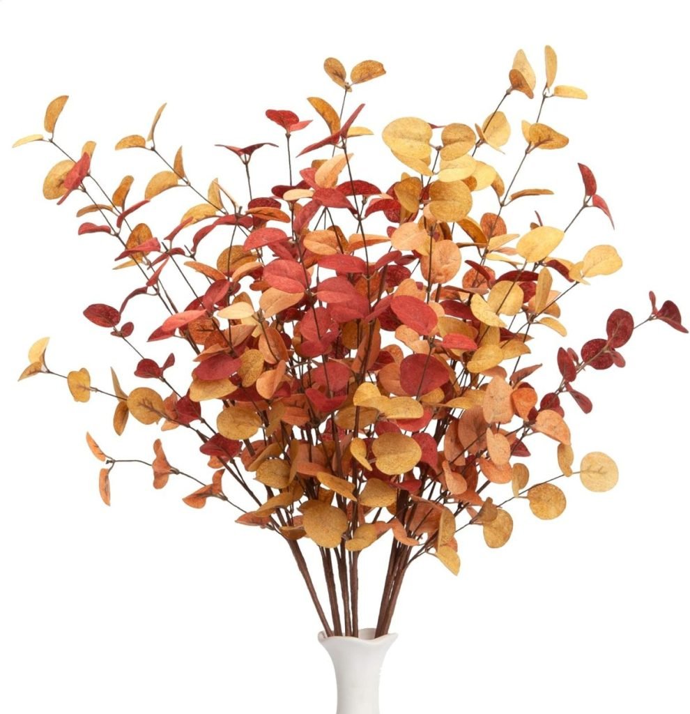 Artificial autumn branches with red, orange, and yellow leaves in a white vase make a perfect fall craft idea.