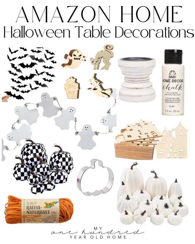 A Halloween table decorated with lights, a spider web, chalkboards, candles, cookies, candy, and more.