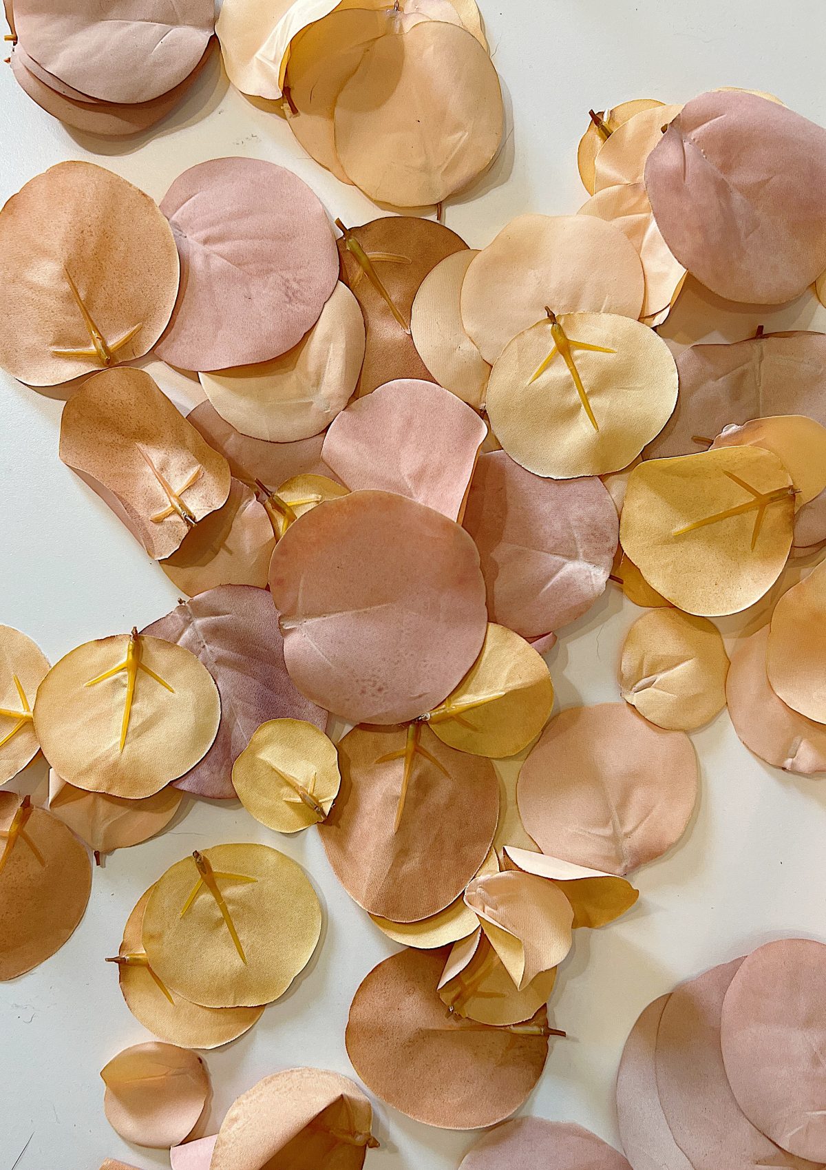 A handmade pumpkin made with a plastic cinderella pumpkin covered with faux eucalyptus leaves.