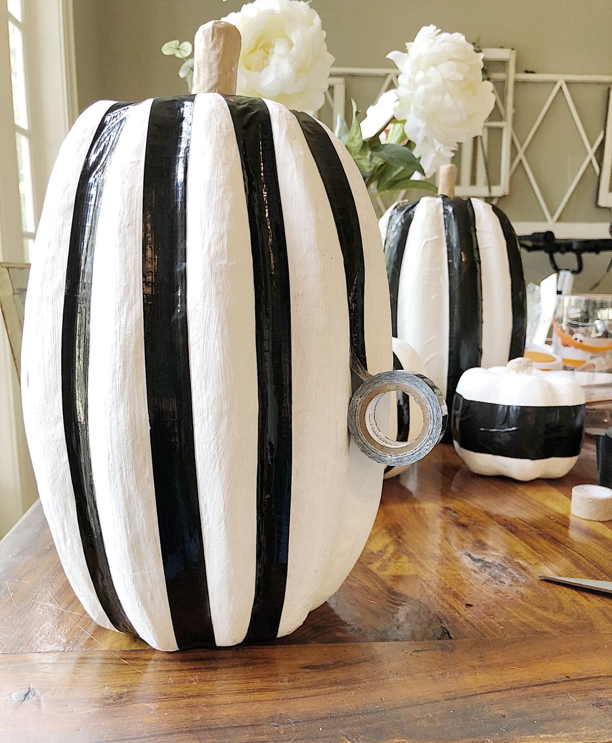 A Halloween table decorated with lights, a spider web, chalkboards, candles, cookies, candy, and more.