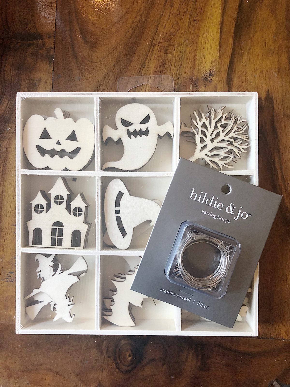 A Halloween table decorated with lights, a spider web, chalkboards, candles, cookies, candy, and more.