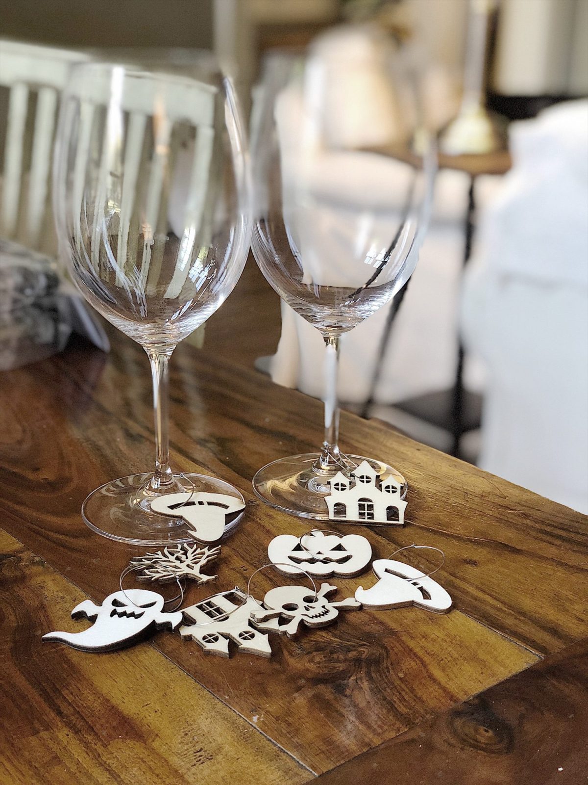 A Halloween table decorated with lights, a spider web, chalkboards, candles, cookies, candy, and more.