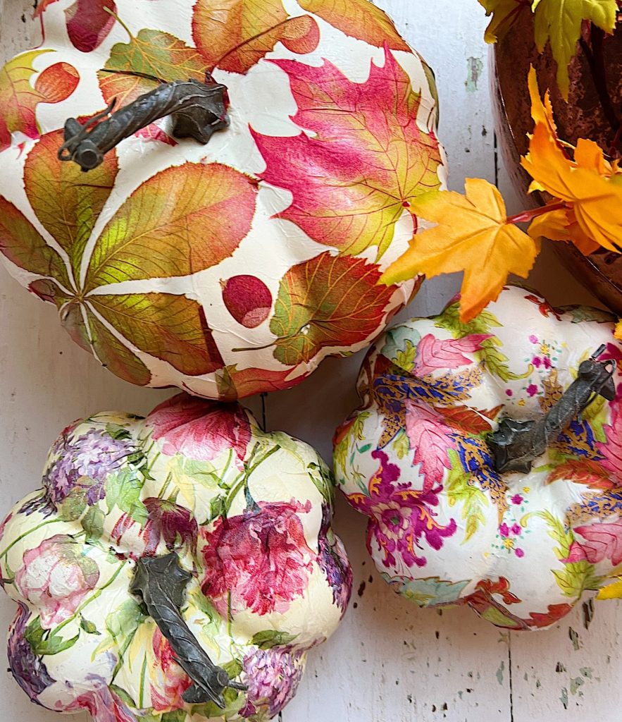 Plastic pumpkins covered with fall paper napkins.