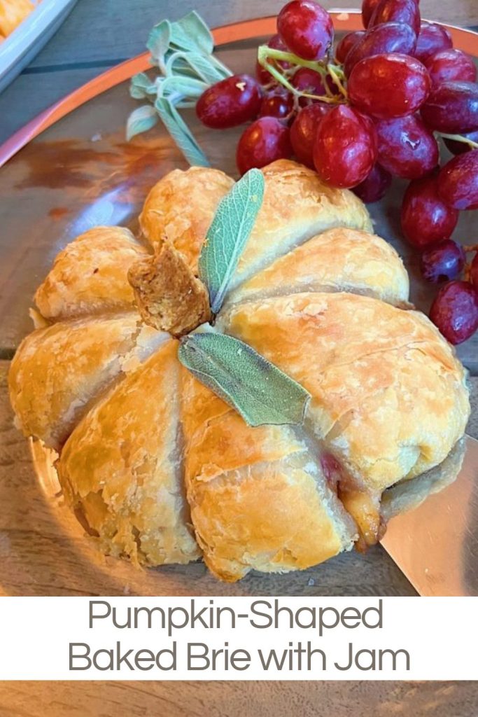 A homemade Pumpkin-Shaped Baked Brie with Jam appetizer. They were such a hit and so easy to make.