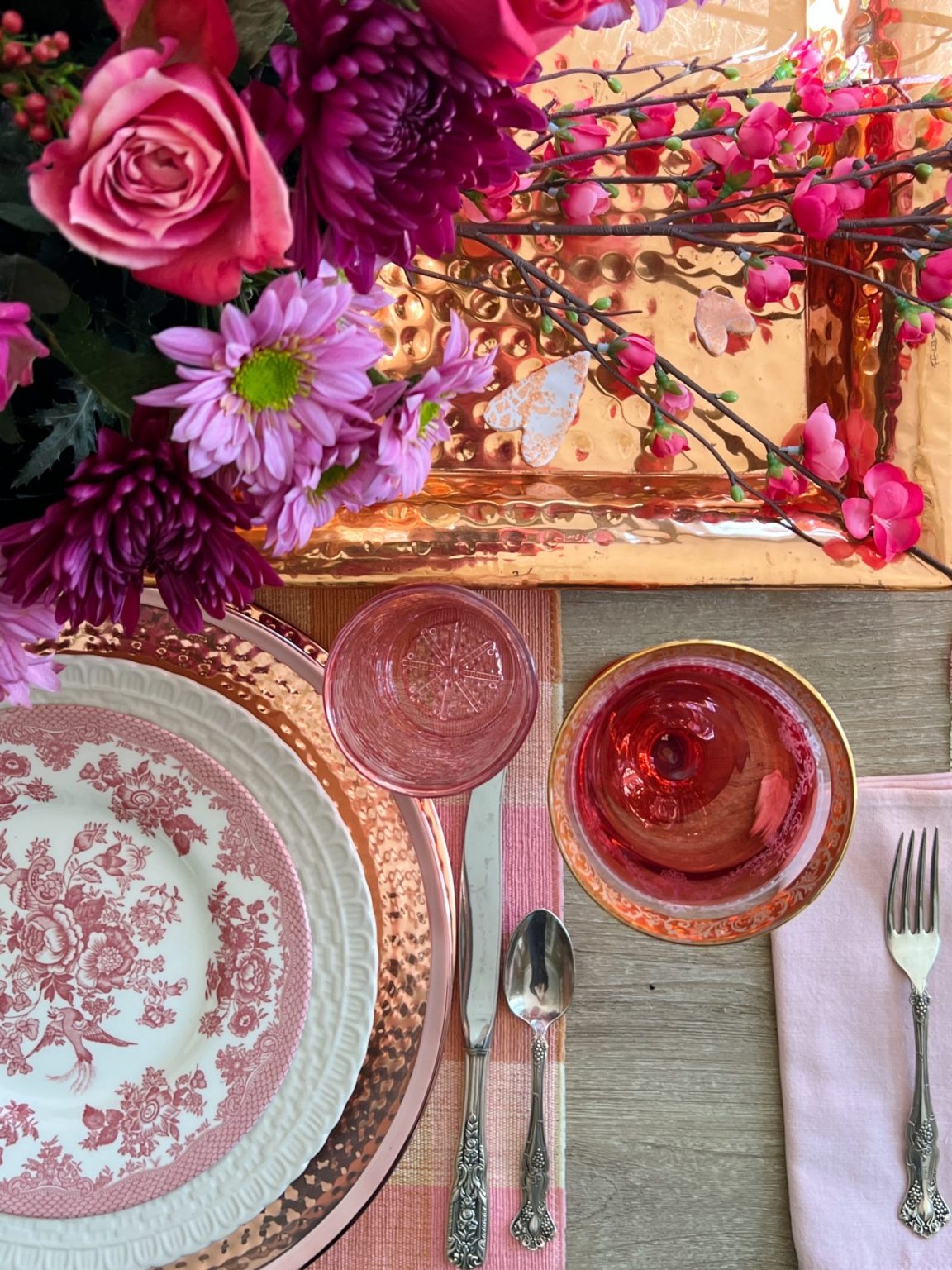 A cranberry copper themed table set for Christmas