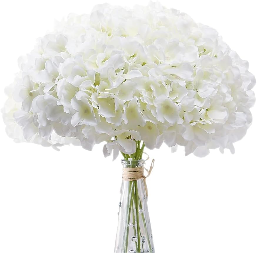 A bouquet of white hydrangeas in a clear glass vase tied with twine evokes the warmth of family traditions.