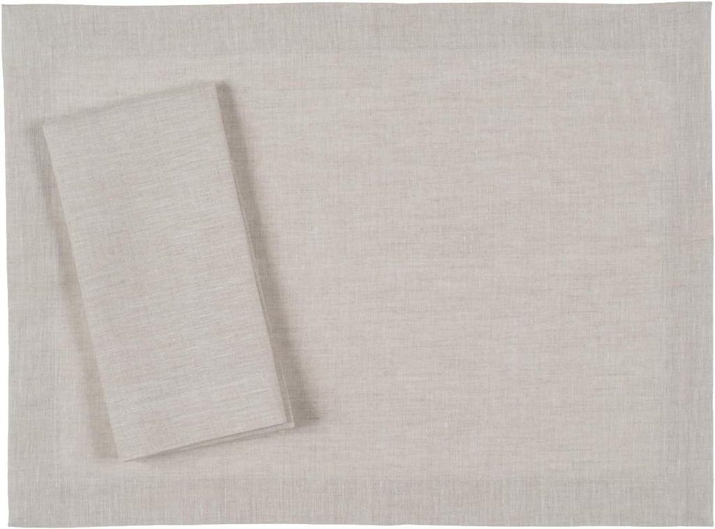 Set a Christmas table with this beige linen placemat and matching folded napkin, perfect against a plain backdrop to highlight your festive decor.