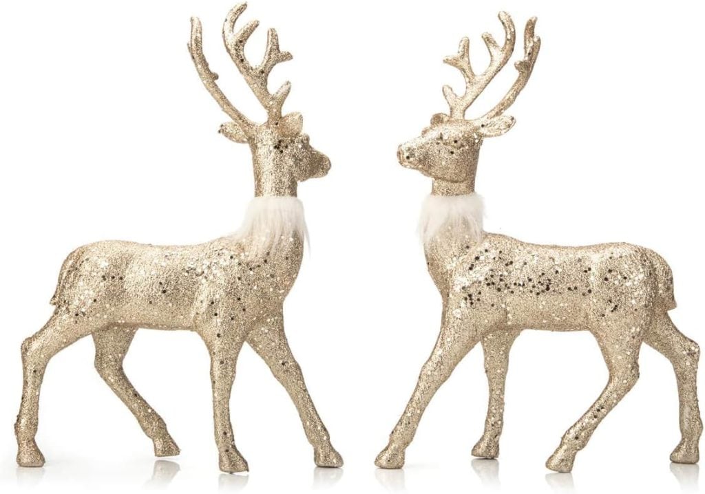 Two gold glitter reindeer figurines with antlers and white neck fur face each other on a white background, perfect for setting a festive Christmas table.