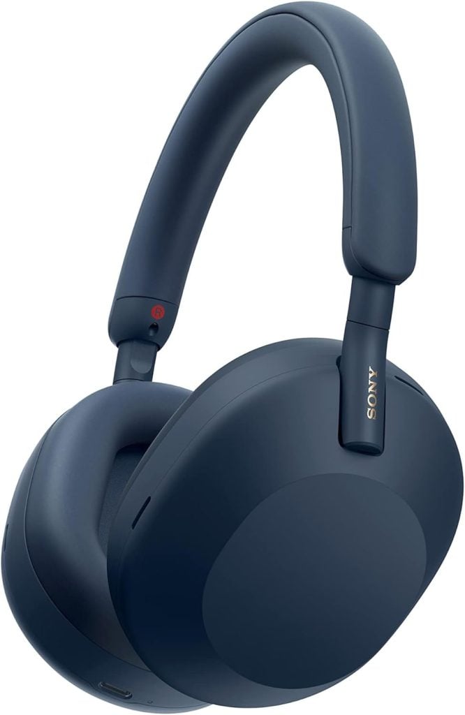 A pair of dark blue over-ear headphones with "Sony" elegantly etched on the side of the headband, reminiscent of a Flocked Christmas Tree's serene winter vibe.