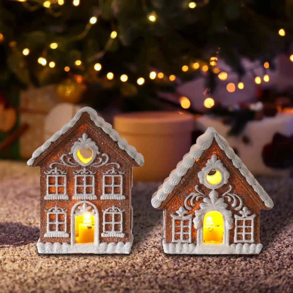 Two decorative Christmas gingerbread houses with glowing interiors sit on a carpet, bathed in warm, yellow lights. In the background, out-of-focus holiday lights add to the festive charm.