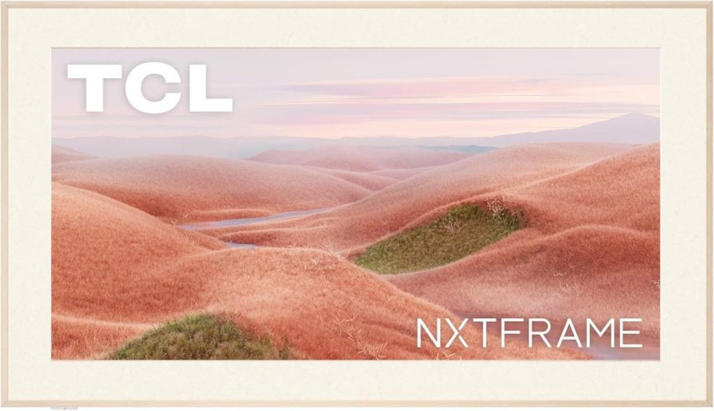 A framed image of a landscape with rolling pink hills under a pastel sky resembles the dreamy allure of a flocked Christmas tree. The words "TCL" and "NXTFAME" are elegantly inscribed on the frame, enhancing its whimsical charm.