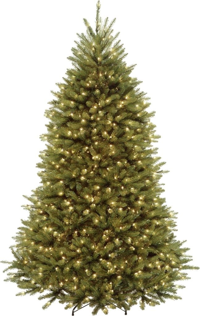 A tall, green Christmas tree is adorned with white lights and has dense, lush branches, embodying cherished family traditions passed down through generations.