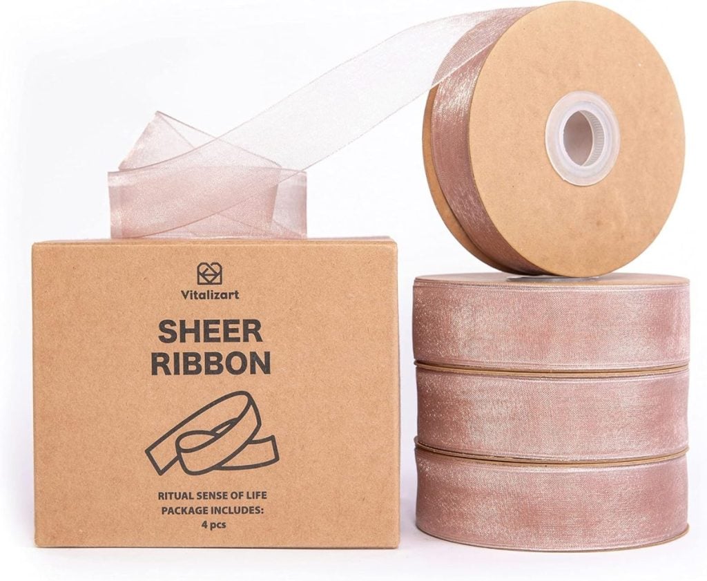 Stacked rolls of sheer ribbon with a box labeled "Vitalizeart Sheer Ribbon, Ritual Sense of Life, Package Includes: 4 pcs." Perfect for adding elegance as you set a Christmas table.