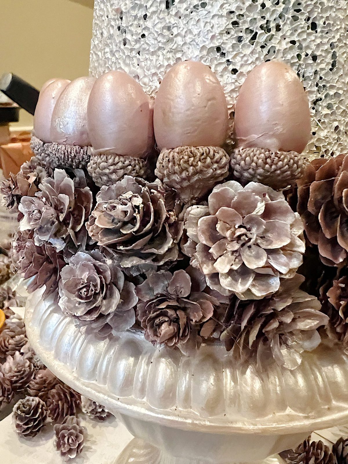 A DIY to make mini Christmas trees decorated with pinecones and acorns.