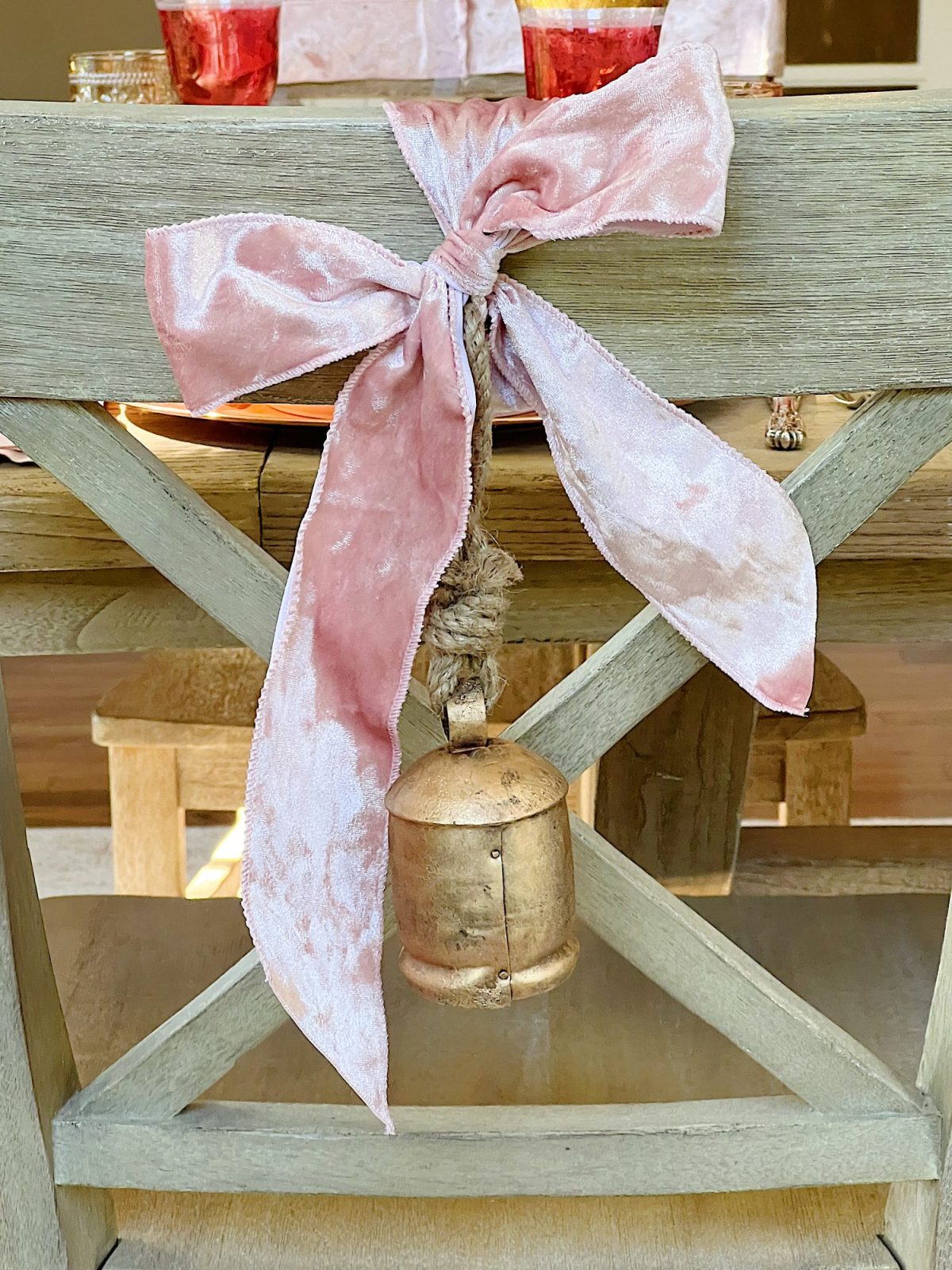 Tying a bow on the back of a dining room chair.