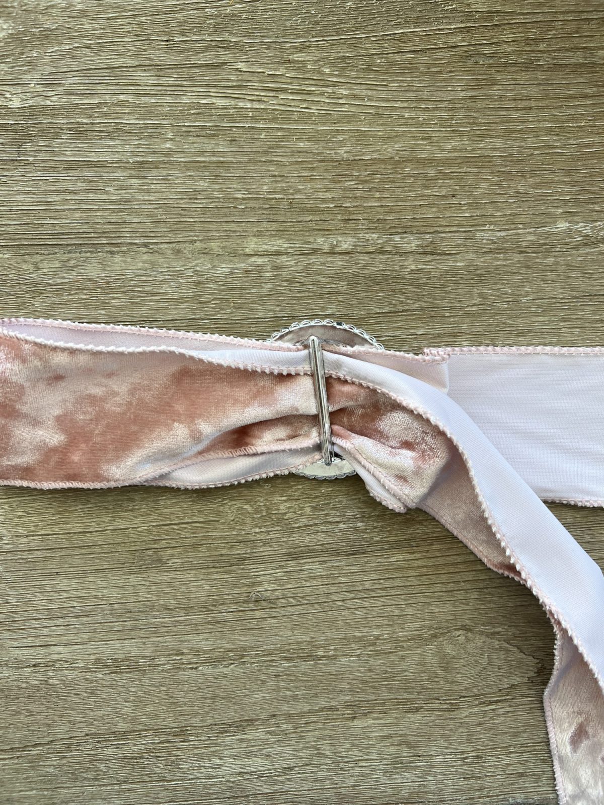 Tying a bow on the back of a dining room chair.