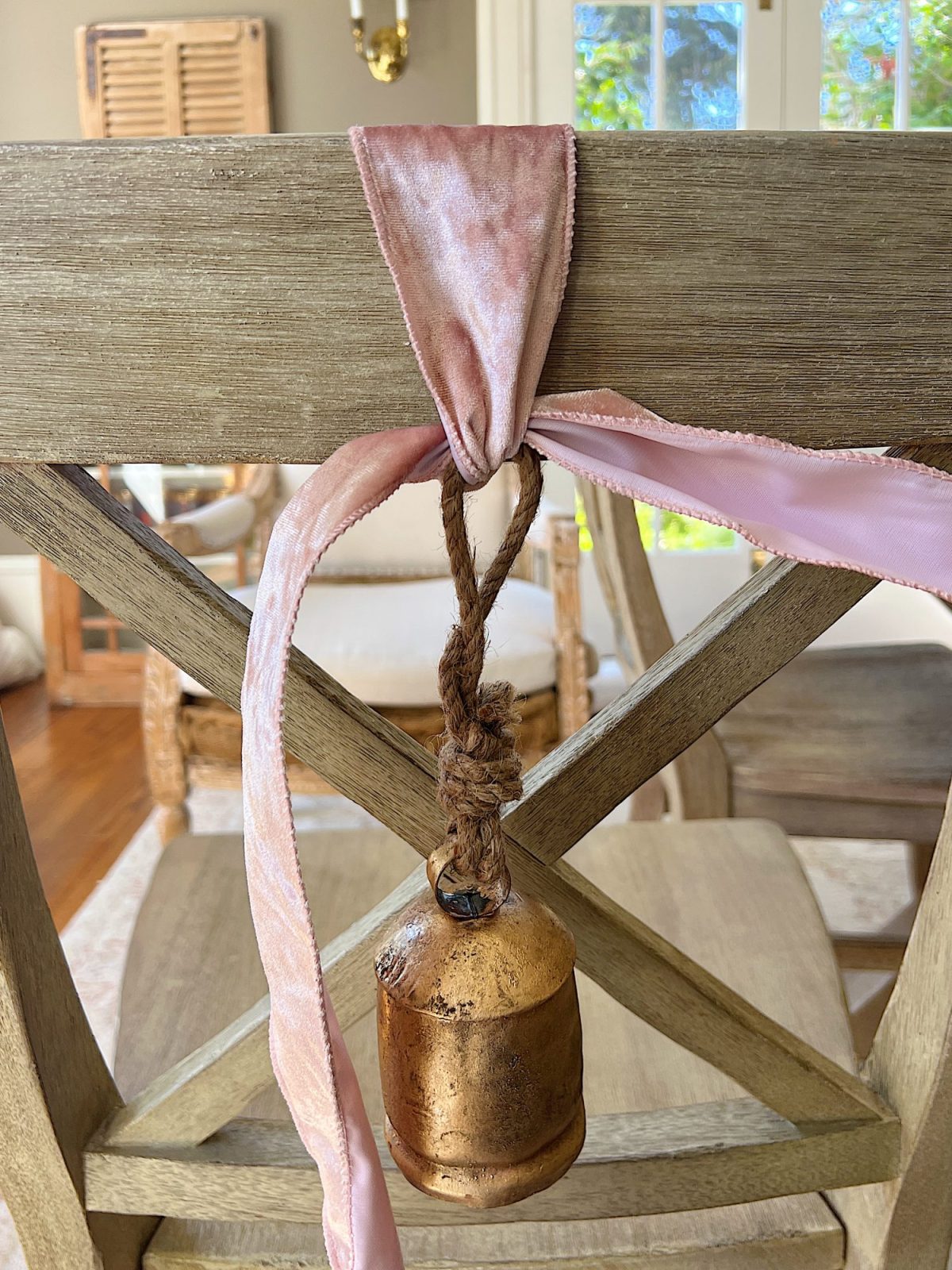 Tying a bow on the back of a dining room chair.