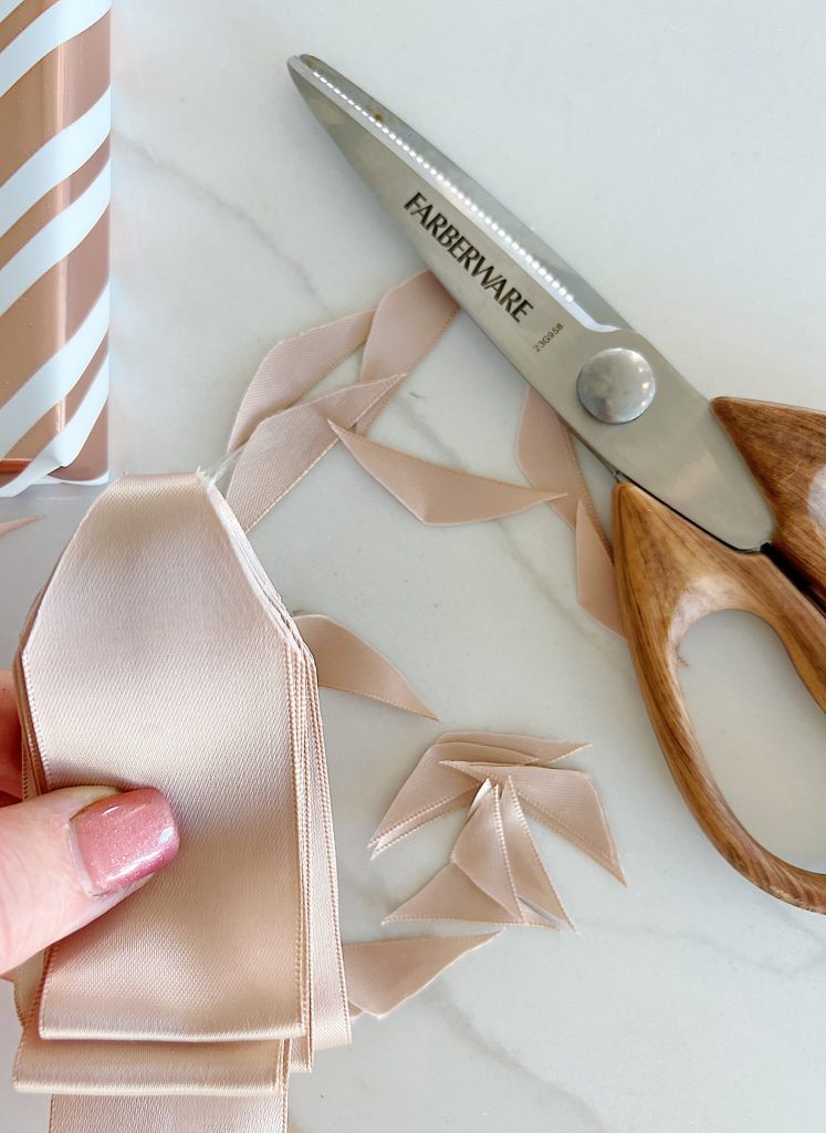 Scissors Cutting Christmas Ribbon While Wrapping A Present by