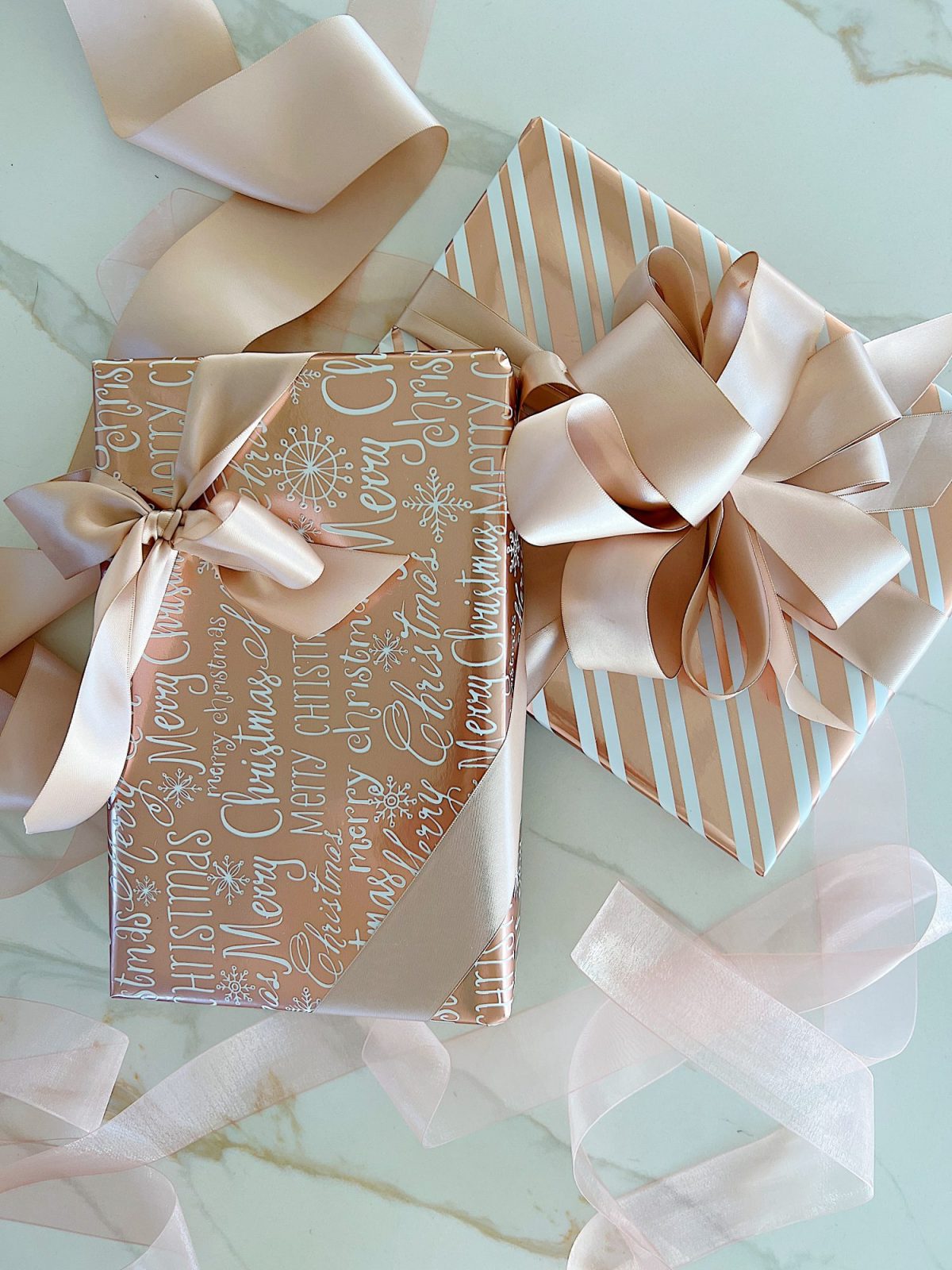 Instructions to tie a bow with ribbon on your Christmas gifts using rose gold metallic wrapping paper and assorted ribbons.