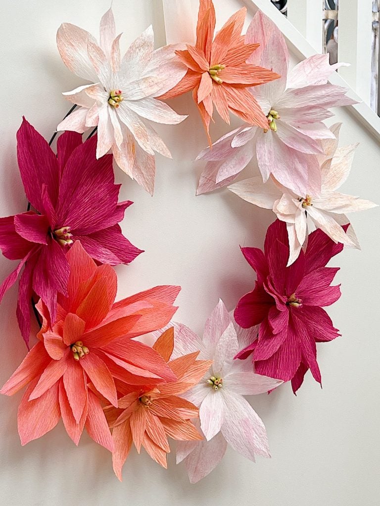 How to make a stunning poinsettia Christmas wreath using crepe paper, wire, and pan pastels.