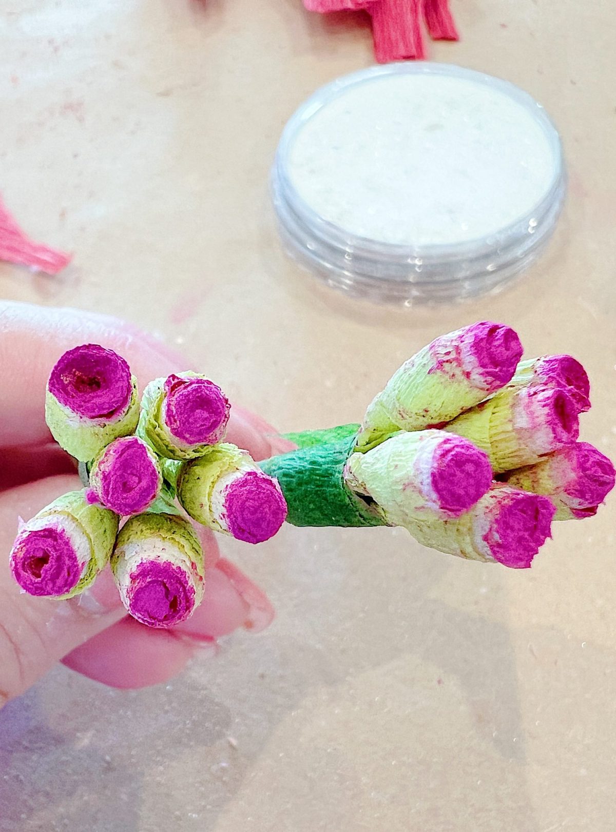 How to make a stunning poinsettia Christmas wreath using crepe paper, wire, and pan pastels.