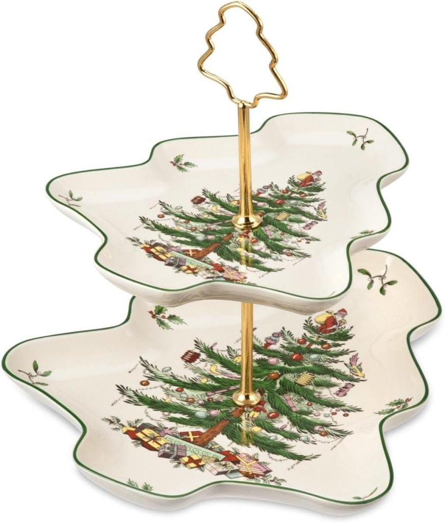 Two-tiered Christmas tree-shaped serving tray with a gold handle, adorned with a festive tree and gifts design, perfect for displaying decorated cookies.