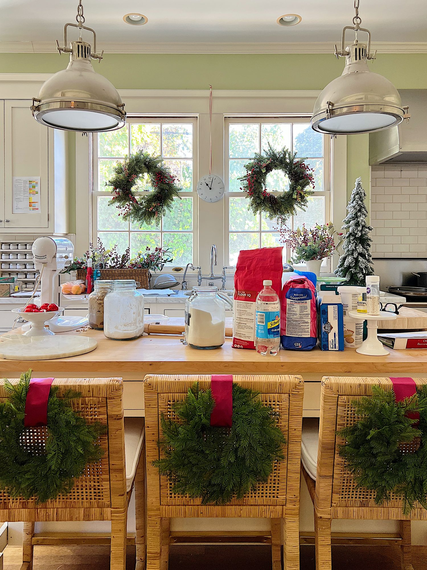 My white kitchen with lots of baking materials on the butcher block island.