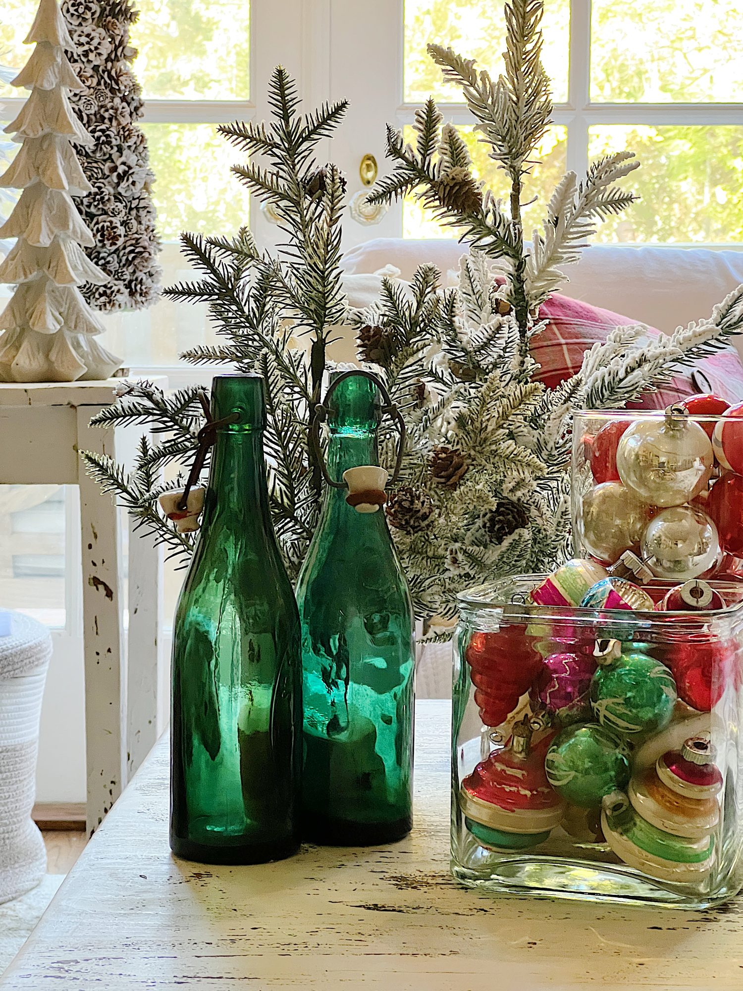 I decorated our family room with faux table top trees, bright colored Christmas balls, and a table set for Christmas morning breakfast.