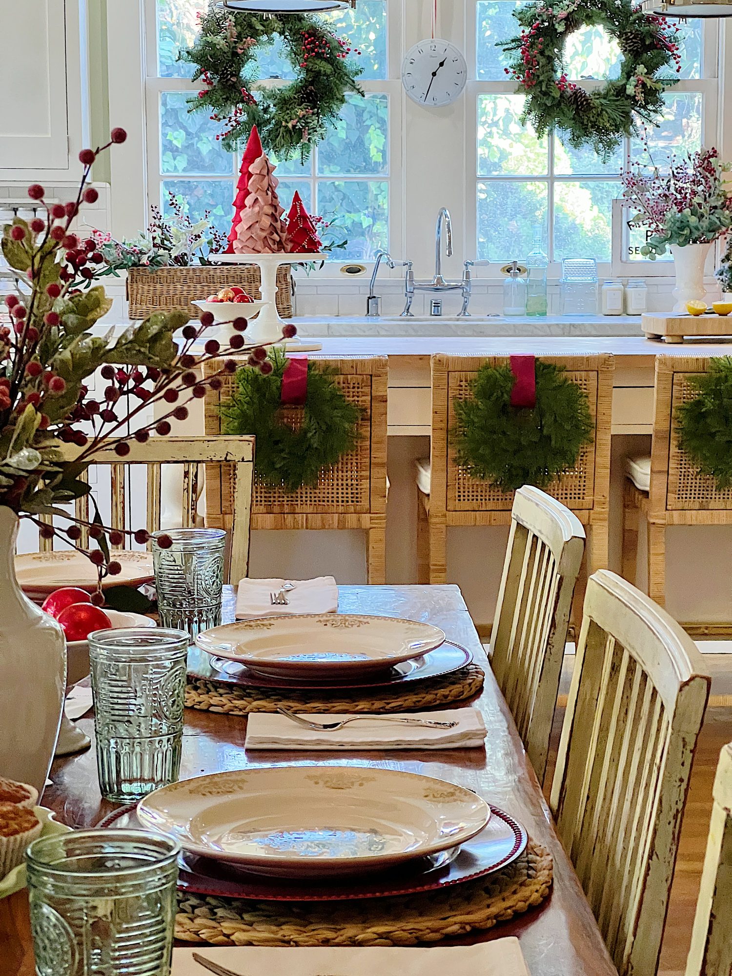 I decorated our family room with faux table top trees, bright colored Christmas balls, and a table set for Christmas morning breakfast.