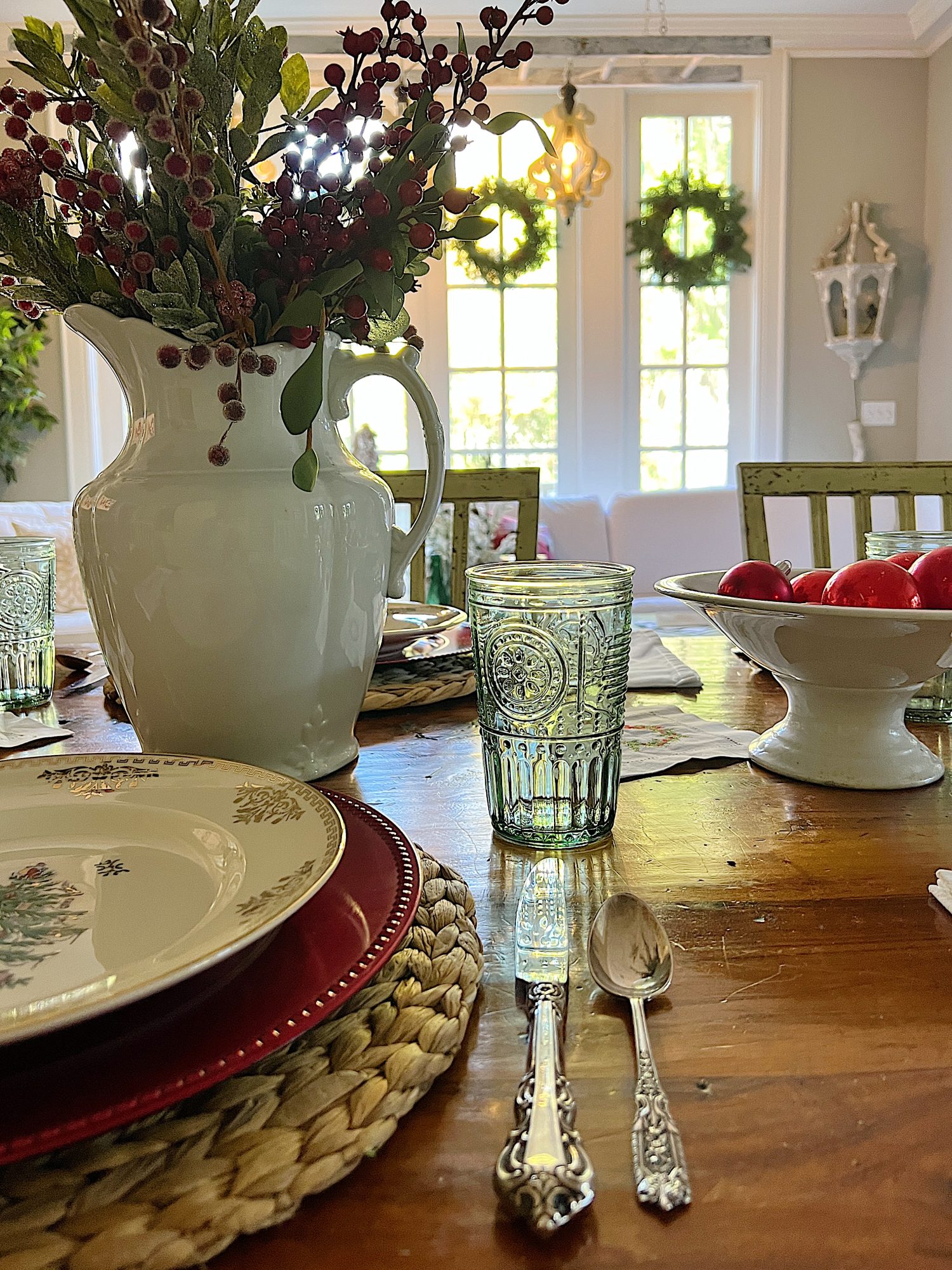 I decorated our family room with faux table top trees, bright colored Christmas balls, and a table set for Christmas morning breakfast.