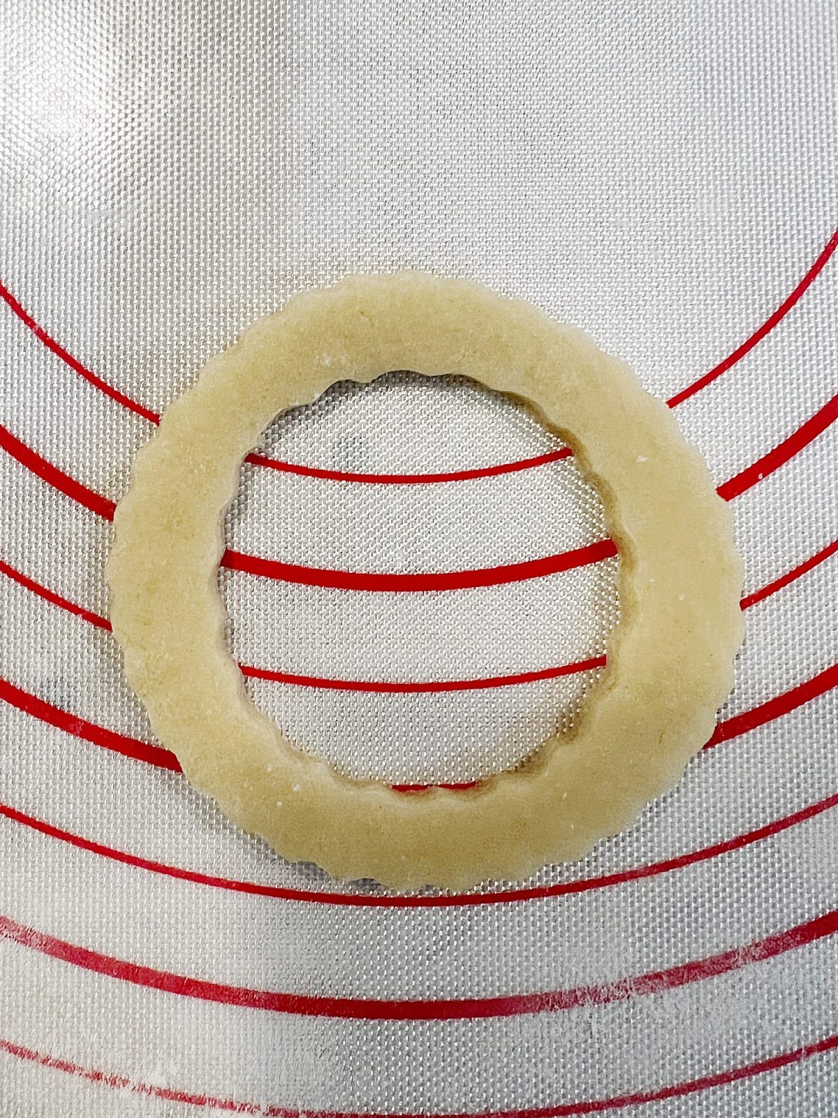 Homemade sugar cookies with buttercream frosting decorated with wafer paper wreaths.