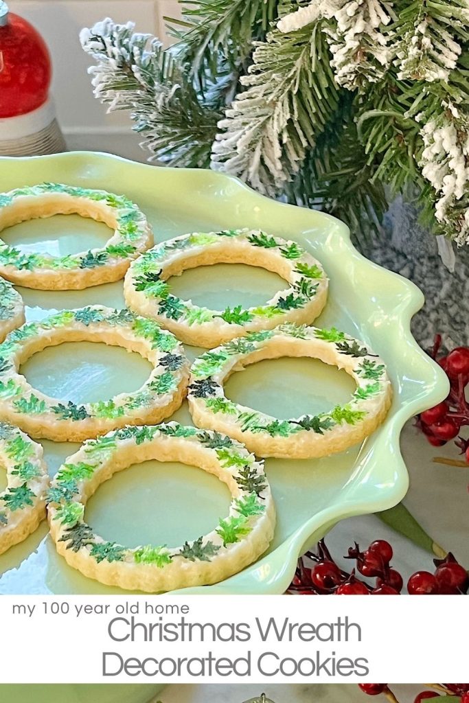 Homemade sugar cookies with buttercream frosting decorated with wafer paper wreaths.