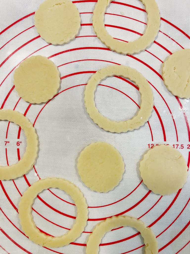 Homemade sugar cookies with buttercream frosting decorated with wafer paper wreaths.